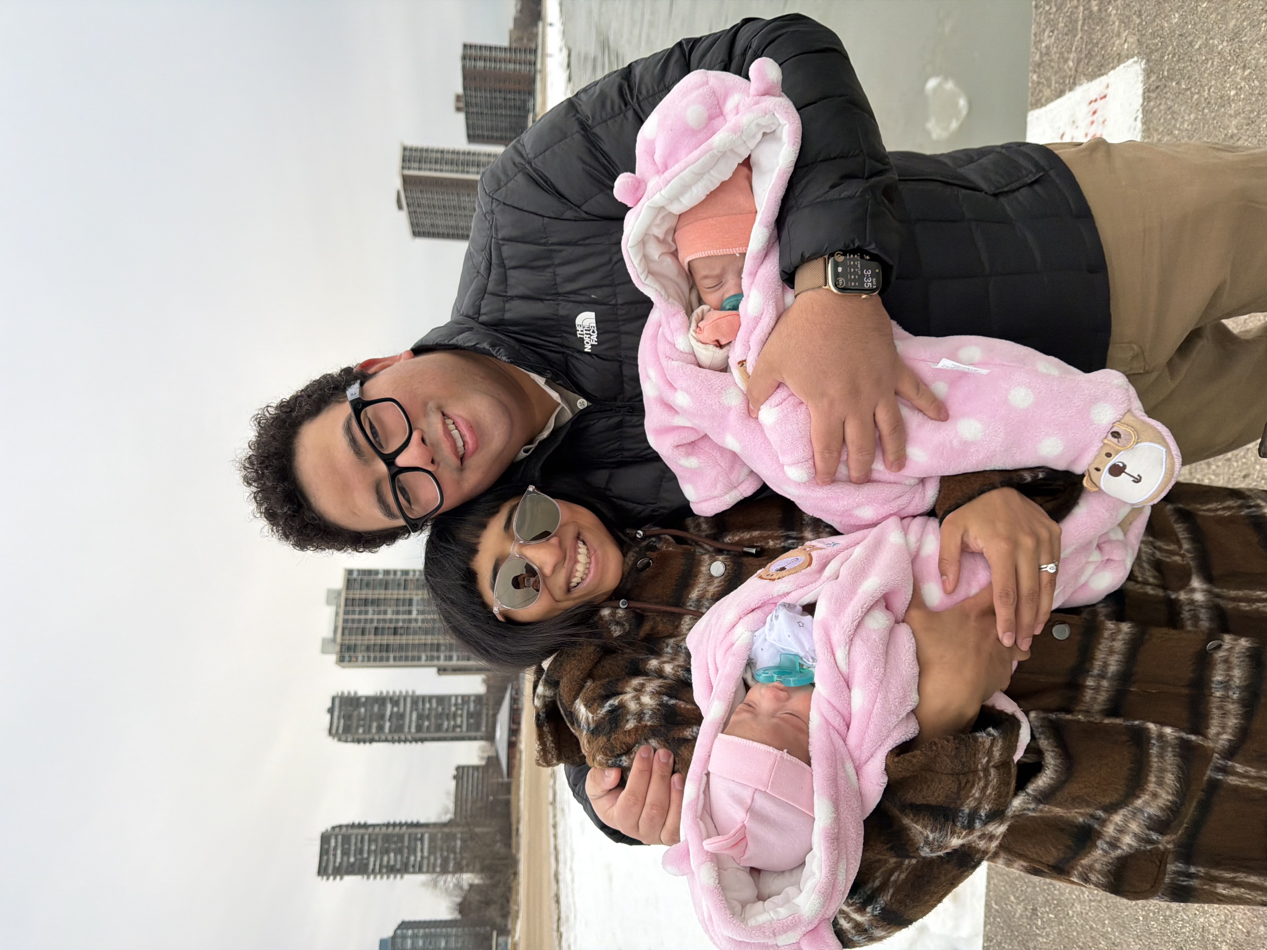 David and his wife holding their babies